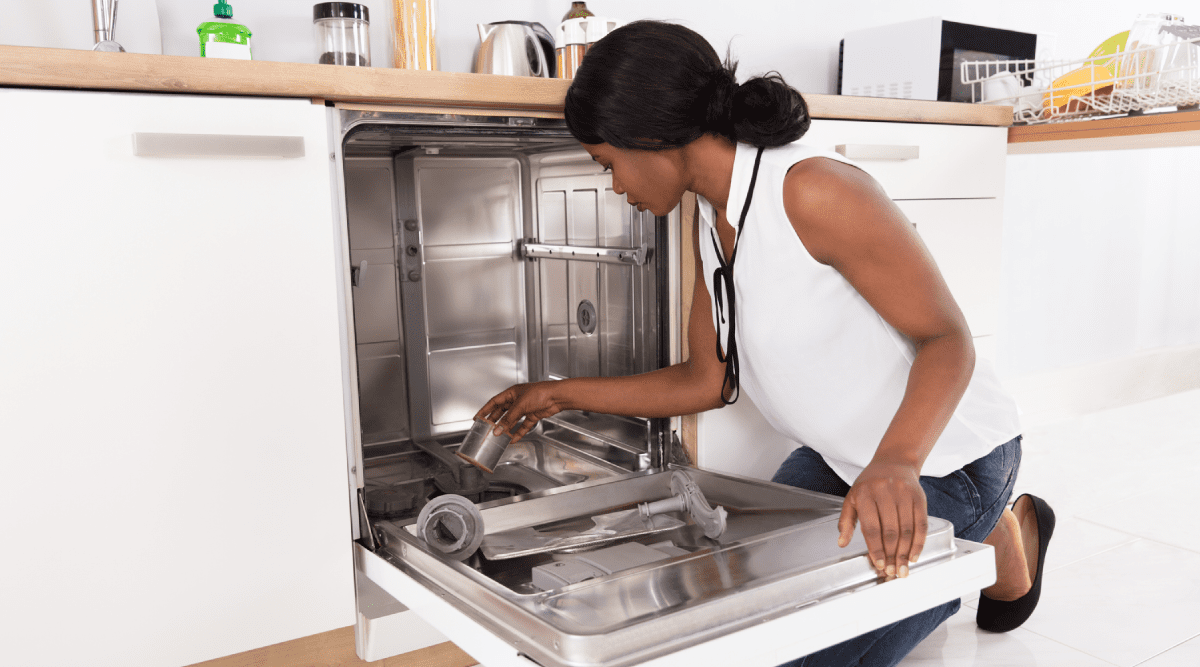 Woman cleaning dishwasher