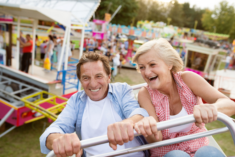 Senior couple riding rollercoaster