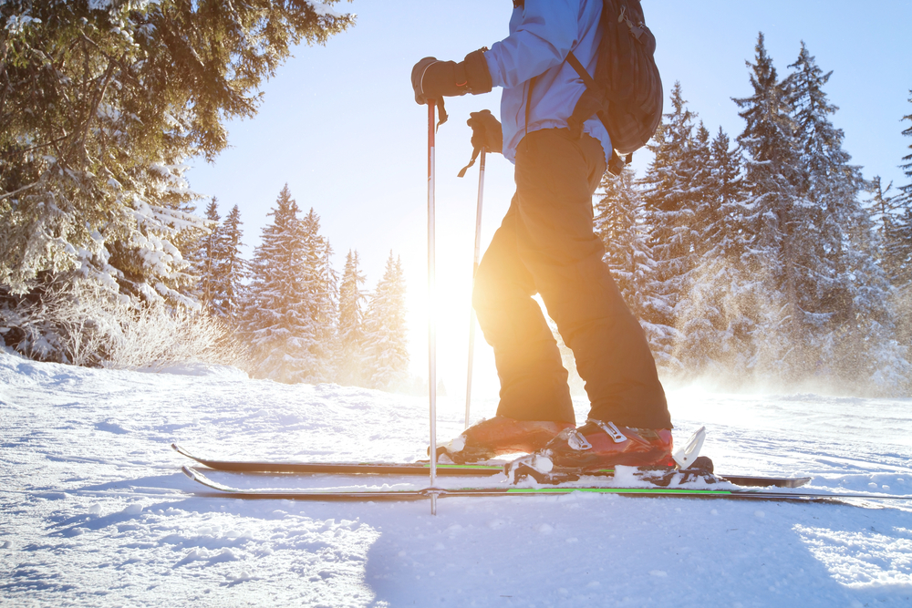 Person skiing with sun setting