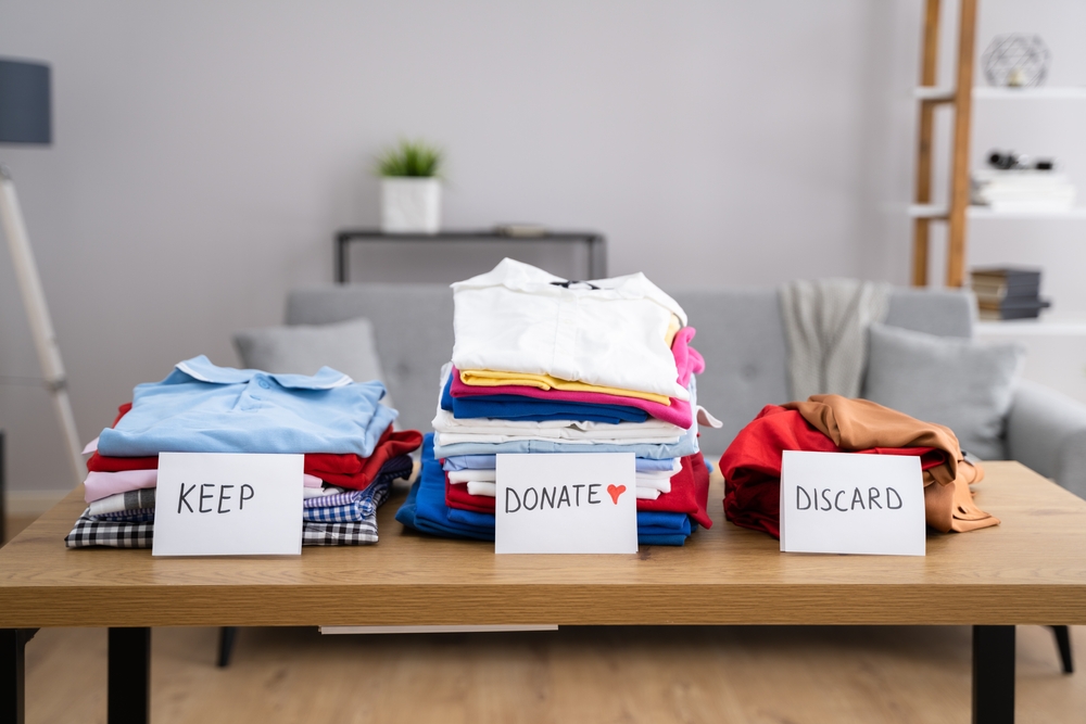Clothing separated into piles for donation