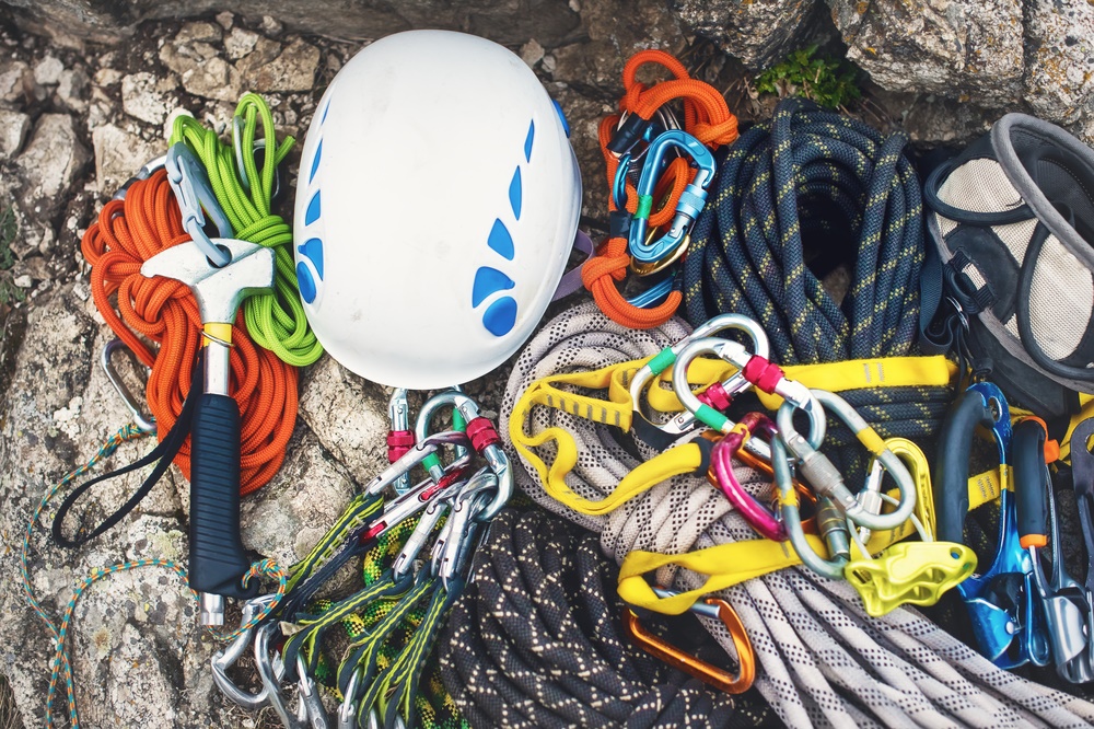 Various rock climbing gear laid out on a rock